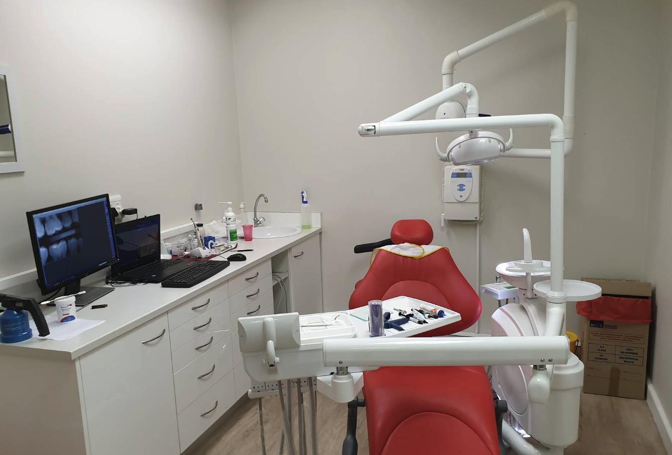 Table View Dental Studio treatment room with dental chair and x-ray monitor
